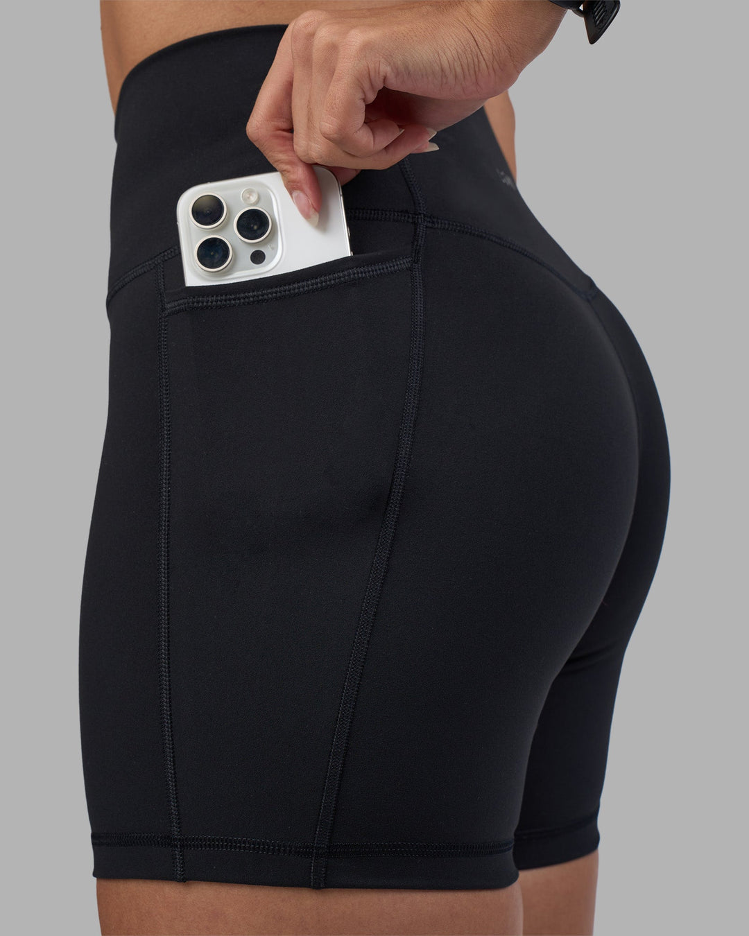 Woman wearing Fusion High-Rise 6&quot; Short Pockets - Black | Model:Rhiley | Size:S