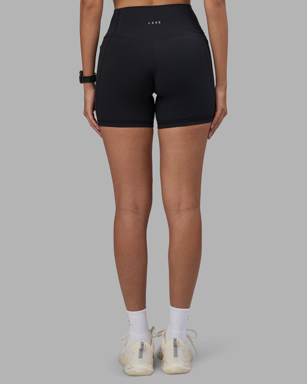 Woman wearing Fusion High-Rise 6&quot; Short Pockets - Black | Model:Rhiley | Size:S