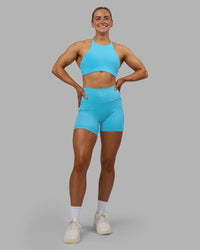 Woman wearing Fusion High-Rise 6" Short Pockets - Blue Atoll | Model:Georgia | Size:S