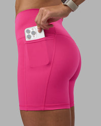 Woman wearing Fusion High-Rise 6" Short Pockets - Ultra Pink | Model:Hannah | Size:S