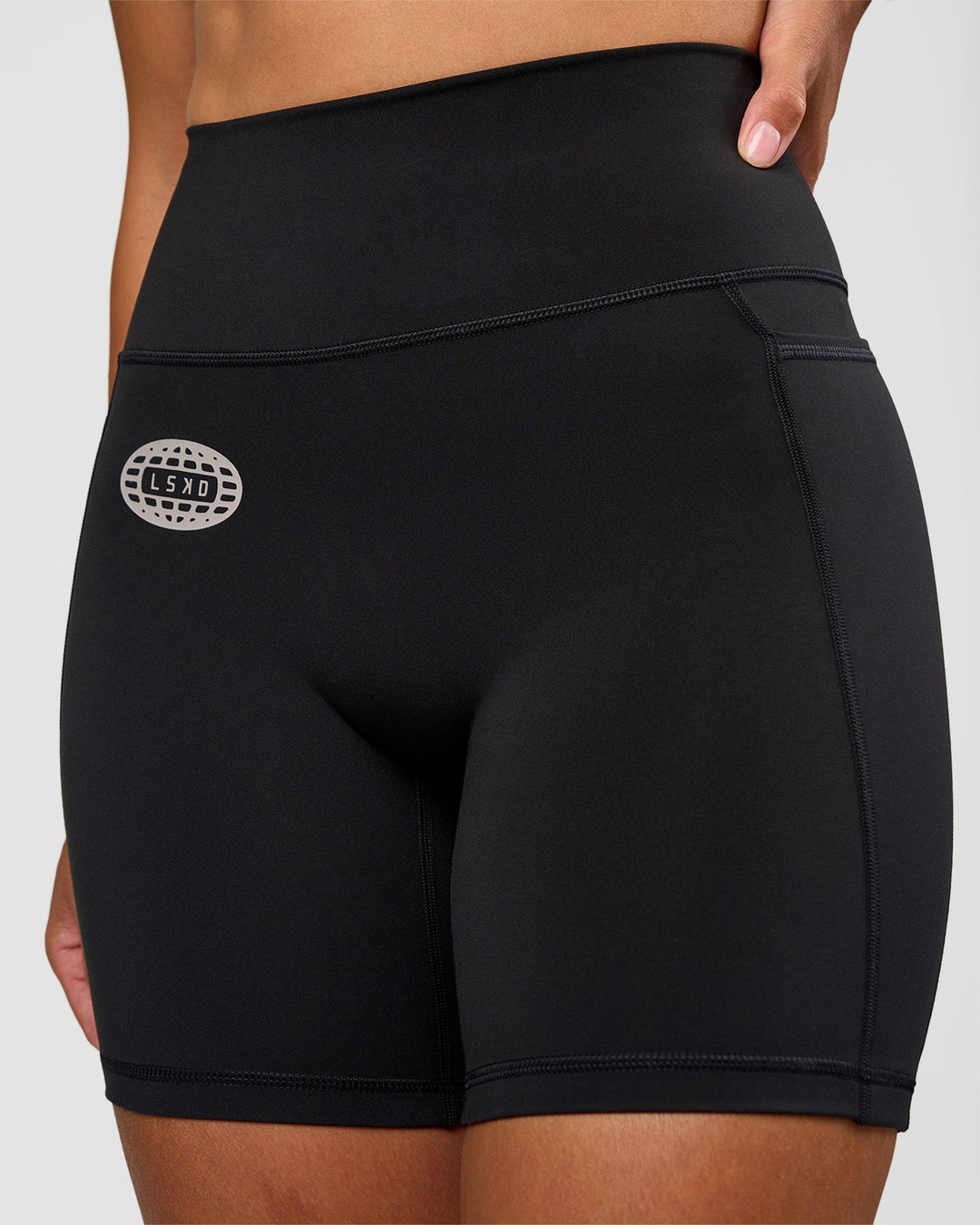Woman wearing Fusion Hype Graphic Ultra High-Rise 6" Short Pockets - Black-Alloy | Model:Rhiley | Size:S