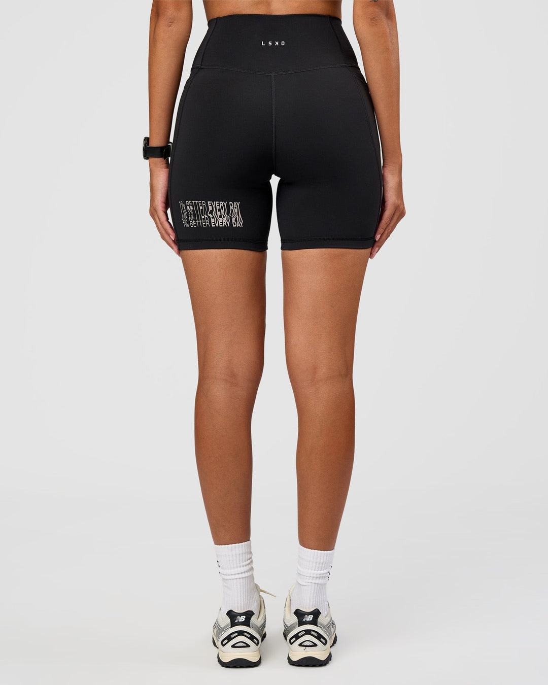 Woman wearing Fusion Hype Graphic Ultra High-Rise 6" Short Pockets - Black-Alloy | Model:Rhiley | Size:S