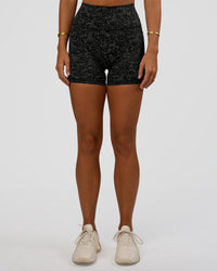 Woman wearing Fusion Icon Ultra High-Rise 4" Short Pockets - Energy Print Black | Model:Amity | Size:S