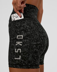 Woman wearing Fusion Icon Ultra High-Rise 6" Short Pockets - Energy Print Black | Model:Amity | Size:S