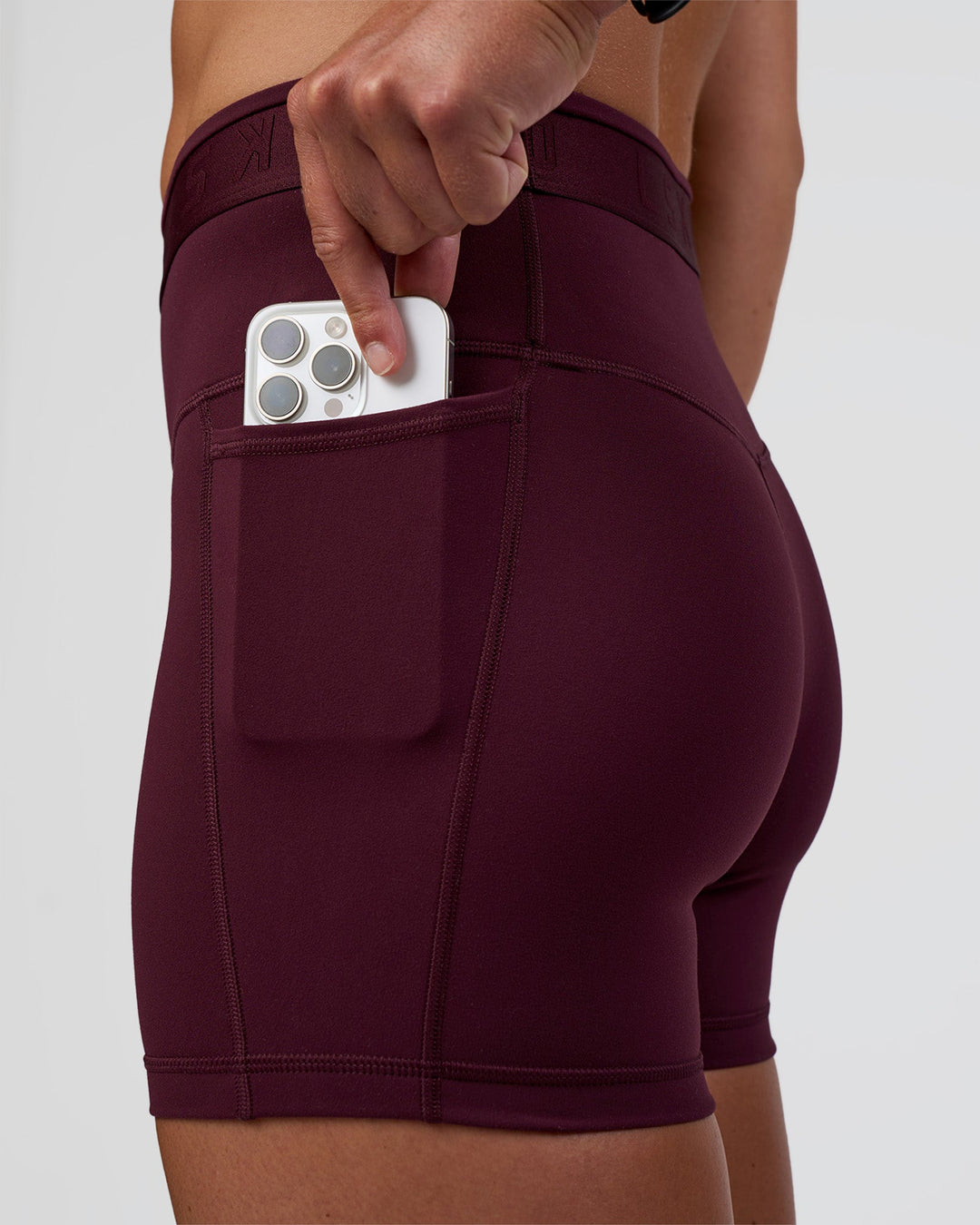 Woman wearing Fusion Jacquard High-Rise 4” Short Pockets - Cherry Lacquer | Model:Sav | Size:S