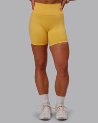 Woman wearing Fusion Ultra High-Rise 6" Short - Banana Cream | Set:true | Angle:front | Model:Amber | Size:S