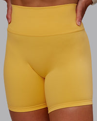 Woman wearing Fusion Ultra High-Rise 6" Short - Banana Cream | Set:true | Angle:closeup | Model:Amber | Size:S