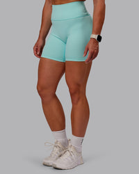 Woman wearing Fusion Ultra High-Rise 6" Short - Island Paradise | Set:true | Angle:side | Model:Amber | Size:S