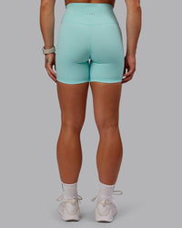 Woman wearing Fusion Ultra High-Rise 6" Short - Island Paradise | Set:true | Angle:back | Model:Amber | Size:S