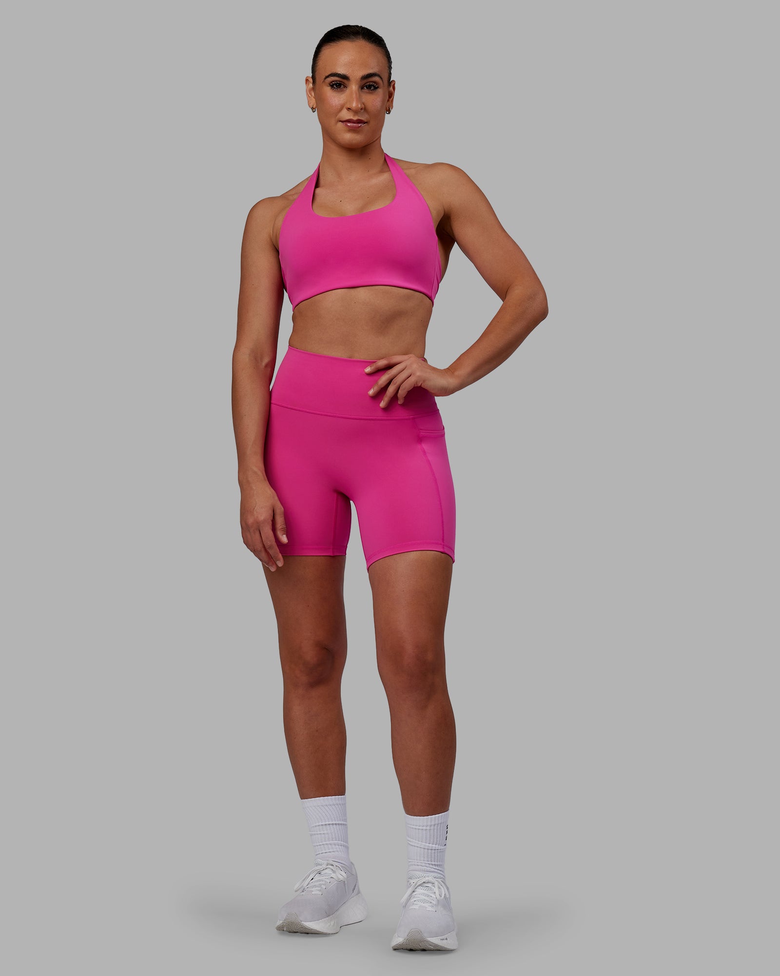 Woman wearing Fusion Ultra High-Rise 6" Short Pockets - Fuchsia Pink | Model:Sophie | Size:S