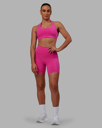 Woman wearing Fusion Ultra High-Rise 6" Short Pockets - Fuchsia Pink | Model:Sophie | Size:S