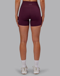 Woman wearing Fusion Ultra High-Rise 6" Short Pockets - Cherry Lacquer | Set:true | Angle:back | Model:Paris | Size:S