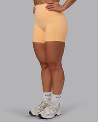 Woman wearing Fusion Ultra High-Rise 6" Short Pockets - Peach Fuzz | Model:Lyss | Size:S