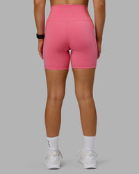 Woman wearing Fusion Ultra High-Rise 6" Short Pockets - Pink Lemonade | Set:true | Angle:back | Model:Halle | Size:S