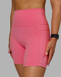 Woman wearing Fusion Ultra High-Rise 6" Short Pockets - Pink Lemonade | Model:Halle | Size:S