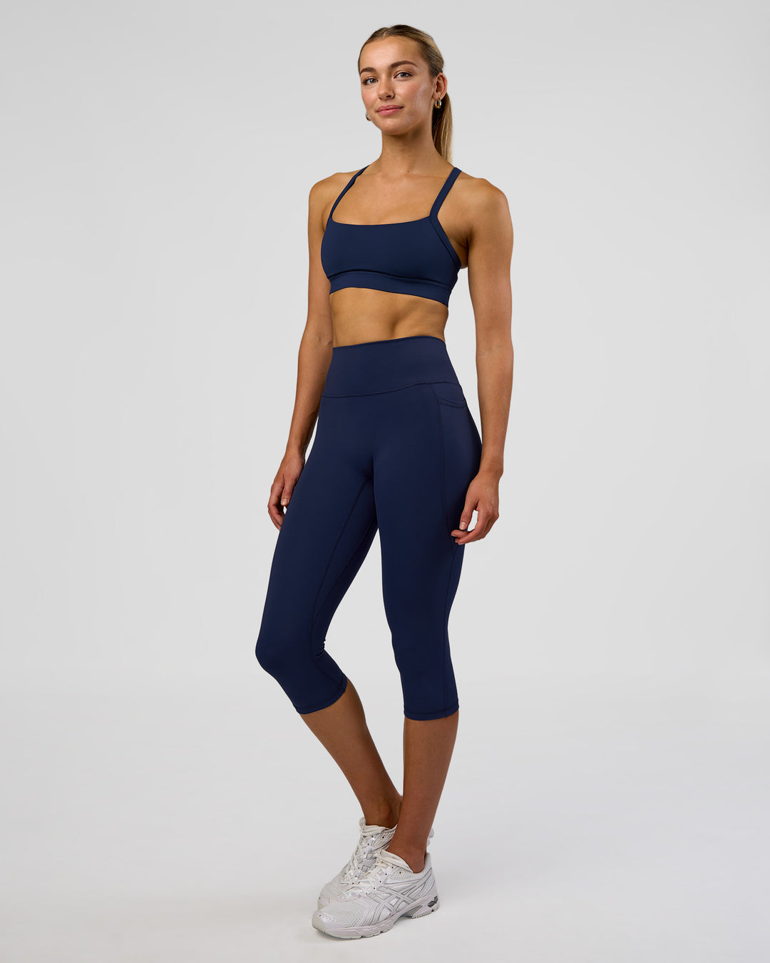Woman wearing Fusion Ultra High-Rise 3/4 Legging Pockets - Future Navy | Model:Evie | Size:S