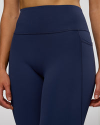 Woman wearing Fusion Ultra High-Rise 3/4 Legging Pockets - Future Navy | Model:Evie | Size:S