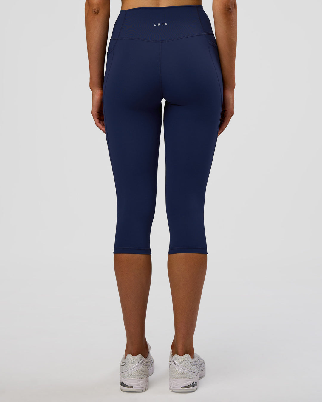 Woman wearing Fusion Ultra High-Rise 3/4 Legging Pockets - Future Navy | Model:Evie | Size:S