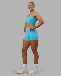 Woman wearing Fusion Ultra High-Rise 4" Short - Blue Atoll | Model:Georgia | Size:S