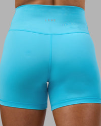 Woman wearing Fusion Ultra High-Rise 4" Short - Blue Atoll | Model:Georgia | Size:S