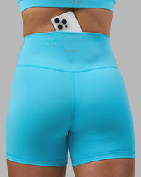 Woman wearing Fusion Ultra High-Rise 4" Short - Blue Atoll | Model:Georgia | Size:S