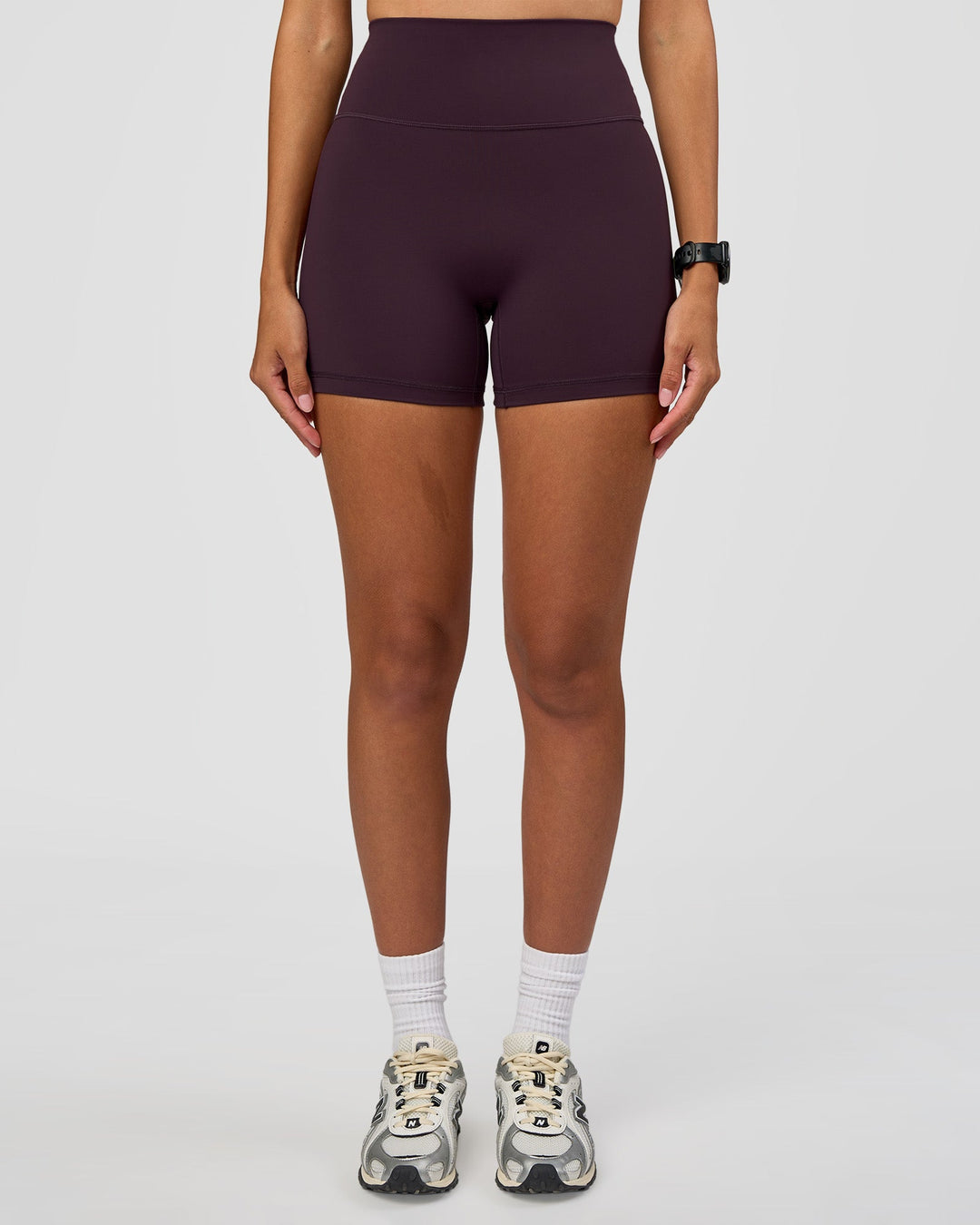 Woman wearing Fusion Ultra High-Rise 4" Short - Midnight Plum | Set:true | Angle:front | Model:Rhiley | Size:S