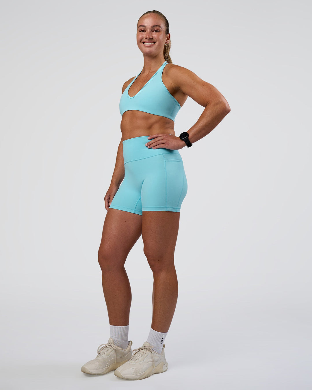 Woman wearing Fusion Ultra High-Rise 4" Short Pockets - Baltic Sea | Model:Sav | Size:S