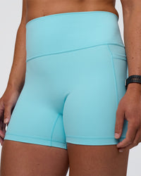 Woman wearing Fusion Ultra High-Rise 4" Short Pockets - Baltic Sea | Model:Sav | Size:S