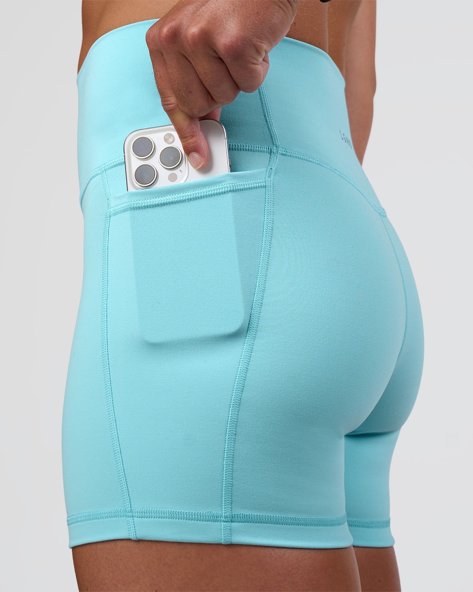 Woman wearing Fusion Ultra High-Rise 4" Short Pockets - Baltic Sea | Set:true | Angle:closeup | Model:Sav | Size:S