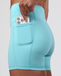 Woman wearing Fusion Ultra High-Rise 4" Short Pockets - Baltic Sea | Set:true | Angle:closeup | Model:Sav | Size:S