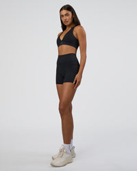 Woman wearing Fusion Ultra High-Rise 4" Short Pockets - Black | Model:Ruby | Size:S