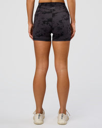 Woman wearing Fusion Ultra High-Rise 4" Short Pockets - Black Tie Dye | Set:true | Angle:back | Model:Amity | Size:S