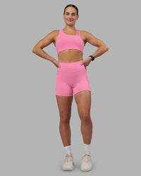 Woman wearing Fusion Ultra High-Rise 4" Short Pockets - Candy Pink | Model:Keisha | Size:S