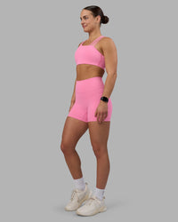 Woman wearing Fusion Ultra High-Rise 4" Short Pockets - Candy Pink | Model:Keisha | Size:S