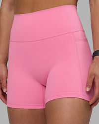 Woman wearing Fusion Ultra High-Rise 4" Short Pockets - Candy Pink | Model:Keisha | Size:S