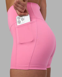 Woman wearing Fusion Ultra High-Rise 4" Short Pockets - Candy Pink | Model:Keisha | Size:S