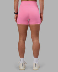 Woman wearing Fusion Ultra High-Rise 4" Short Pockets - Candy Pink | Model:Keisha | Size:S
