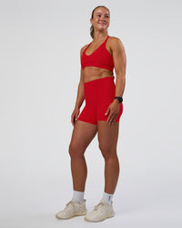 Woman wearing Fusion Ultra High-Rise 4" Short Pockets - Flame | Model:Sav | Size:S