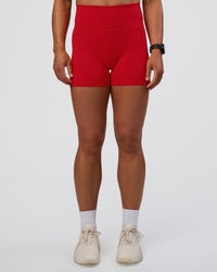 Woman wearing Fusion Ultra High-Rise 4" Short Pockets - Flame | Set:true | Angle:front | Model:Sav | Size:S