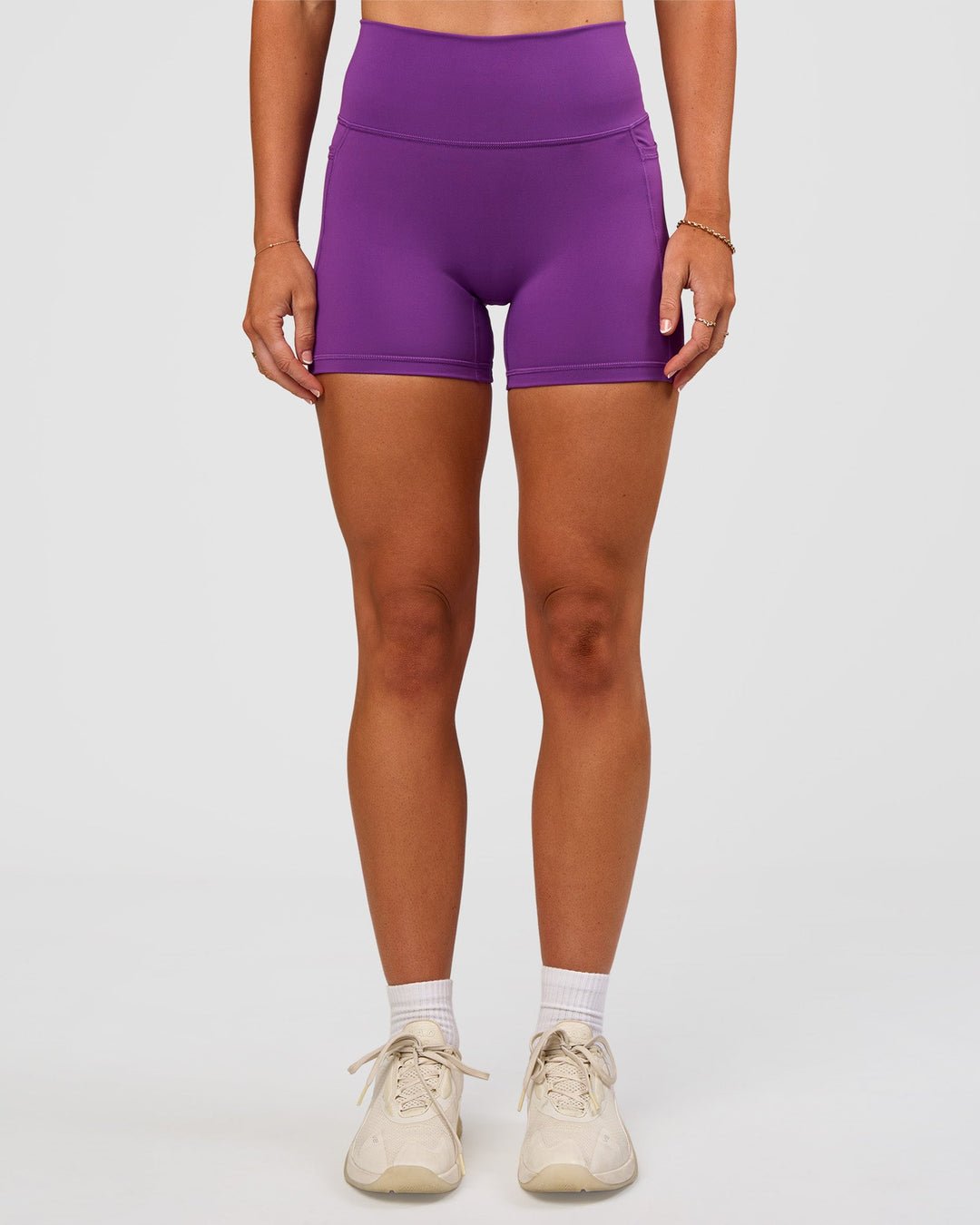 Woman wearing Fusion Ultra High-Rise 4" Short Pockets - Fresh Purple | Set:true | Angle:front | Model:Emelia | Size:S