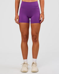 Woman wearing Fusion Ultra High-Rise 4" Short Pockets - Fresh Purple | Set:true | Angle:front | Model:Emelia | Size:S