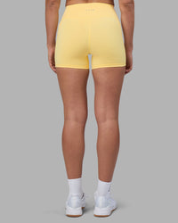 Woman wearing Fusion Ultra High-Rise 4" Short Pockets - Lemon | Set:true | Angle:back | Model:Sophie | Size:S
