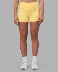Woman wearing Fusion Ultra High-Rise 4" Short Pockets - Lemon | Set:true | Angle:front | Model:Sophie | Size:S