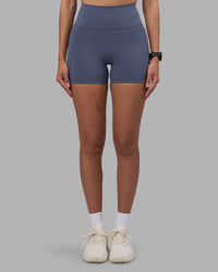 Woman wearing Fusion Ultra High-Rise 4" Short Pockets - Night Shadow | Set:true | Angle:front | Model:Rhiley | Size:S