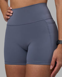 Woman wearing Fusion Ultra High-Rise 4" Short Pockets - Night Shadow | Model:Rhiley | Size:S
