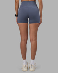 Woman wearing Fusion Ultra High-Rise 4" Short Pockets - Night Shadow | Set:true | Angle:back | Model:Rhiley | Size:S