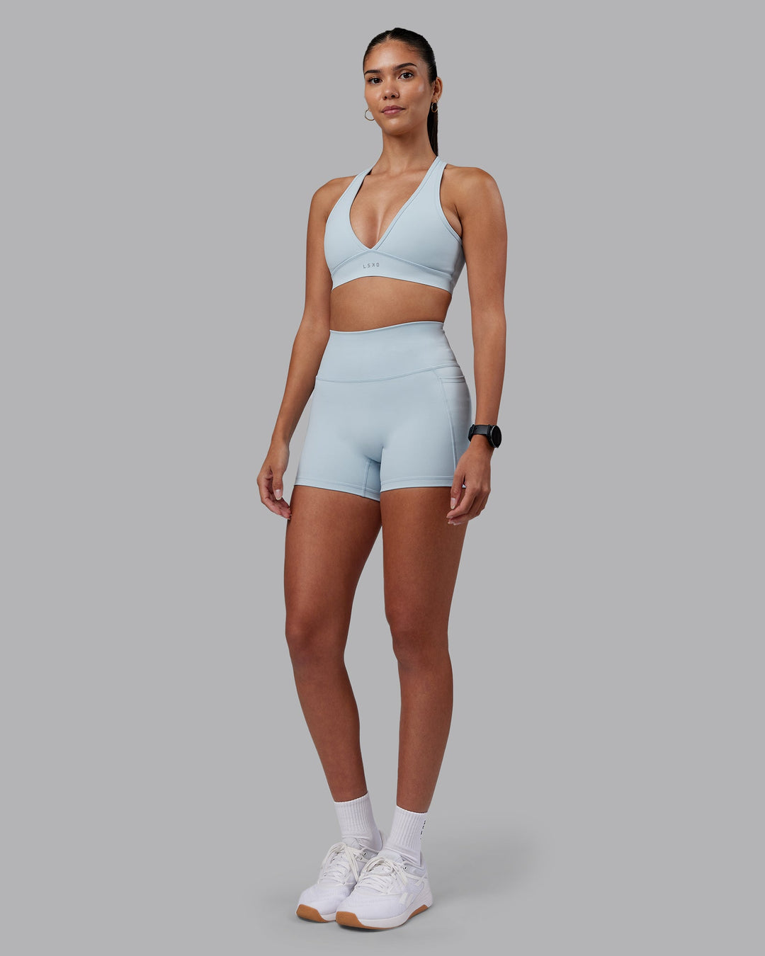 Woman wearing Fusion Ultra High-Rise 4" Short Pockets - Skyride | Model:Rhiley | Size:S
