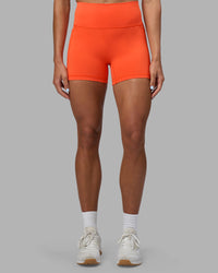Woman wearing Fusion Ultra High-Rise 4" Short Pockets - Ultra Orange | Set:true | Angle:front | Model:Katie | Size:S
