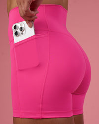 Woman wearing Fusion Ultra High-Rise 4" Short Pockets - Ultra Pink | Set:true | Angle:closeup | Model:Hannah | Size:S