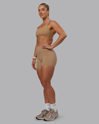 Woman wearing Fusion Ultra High-Rise 4" Short Pockets - Warm Smoke | Model:Lyss | Size:S